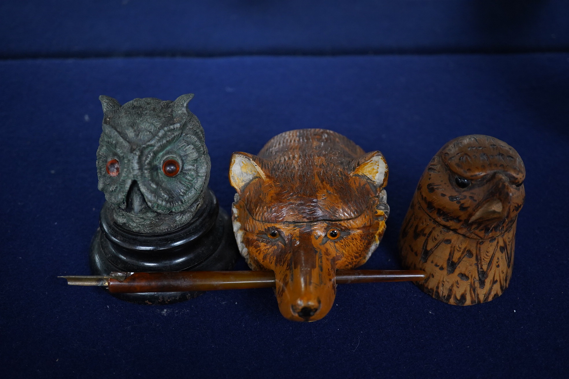 Two carved wood novelty inkwells in the form of animals, one with pen, together with a lead owl inkwell, largest 9cm high. Condition - fair